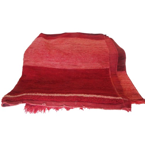 714 - A red ground rug with deep pile, 200cm x 175cm