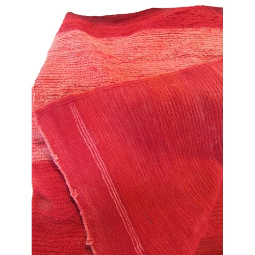 714 - A red ground rug with deep pile, 200cm x 175cm