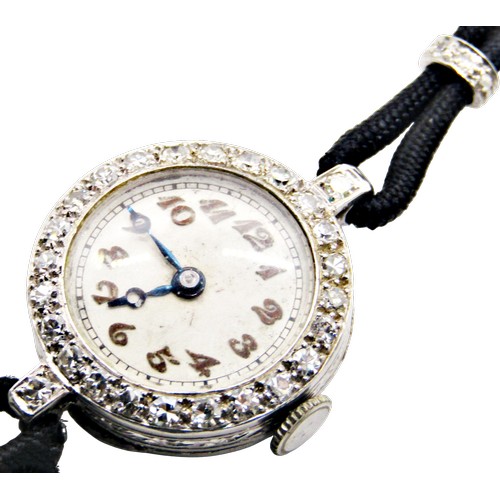 418 - An Art Deco period diamond set platinum cased cocktail wristwatch, the circular dial populated with ... 