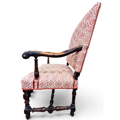 573 - A late 17th century walnut armchair, with acanthus carved arms and handrests, raised on turned legs ... 