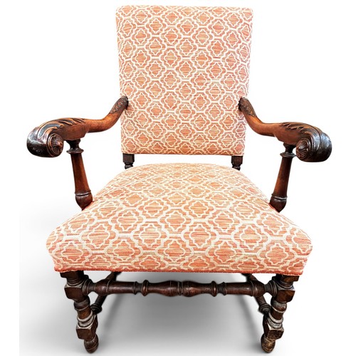 573 - A late 17th century walnut armchair, with acanthus carved arms and handrests, raised on turned legs ... 
