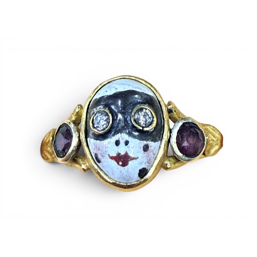 33 - A gem-set gold and enamel masquerade ring, the central mask with inset old cut diamond eyes flanked ... 