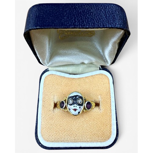 33 - A gem-set gold and enamel masquerade ring, the central mask with inset old cut diamond eyes flanked ... 