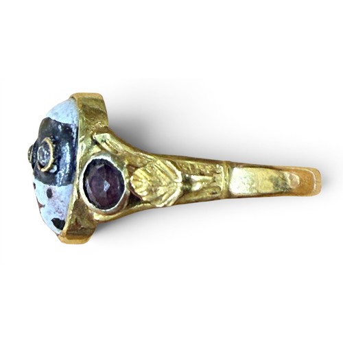33 - A gem-set gold and enamel masquerade ring, the central mask with inset old cut diamond eyes flanked ... 
