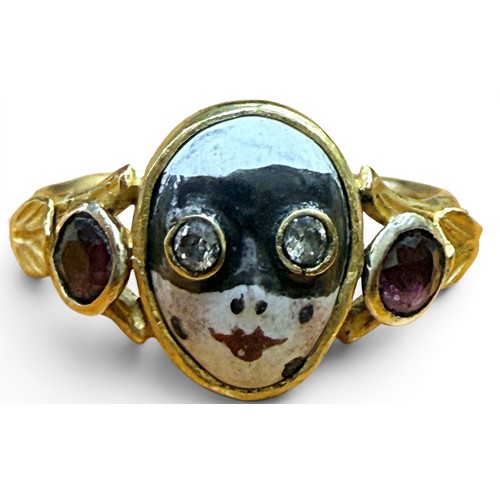33 - A gem-set gold and enamel masquerade ring, the central mask with inset old cut diamond eyes flanked ... 