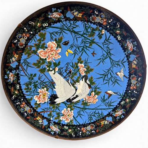 473 - An unusually large Japanese cloisonné enamel charger, decorated with cranes, sparrows and butterflie... 