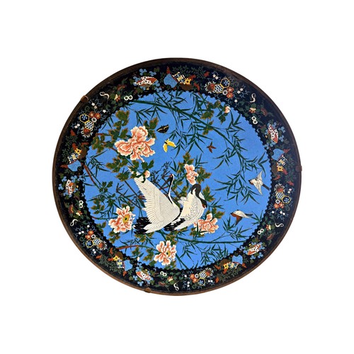 473 - An unusually large Japanese cloisonné enamel charger, decorated with cranes, sparrows and butterflie... 