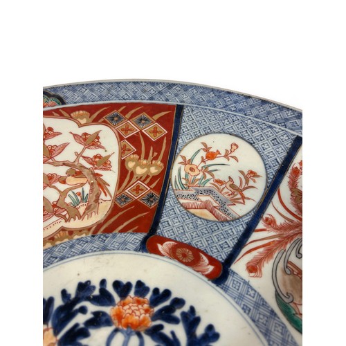 55 - A large 19th century Imari charger with a repeating floral and other detail. 45cm in diameter.