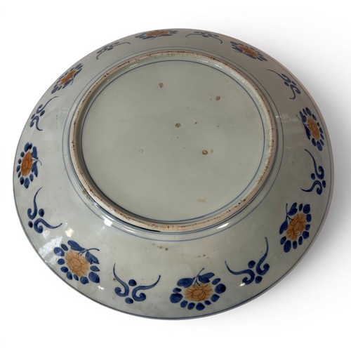 55 - A large 19th century Imari charger with a repeating floral and other detail. 45cm in diameter.