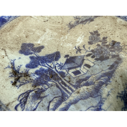 52 - A 19th century blue and white Chinese porcelain charger 40cm diameter with landscaped detail and sta... 