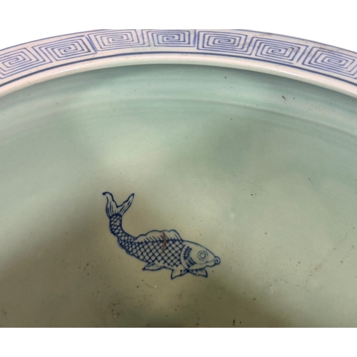 54 - A 20th century Chinese carp bowl with detail showing butterflies. 31cm in diameter.