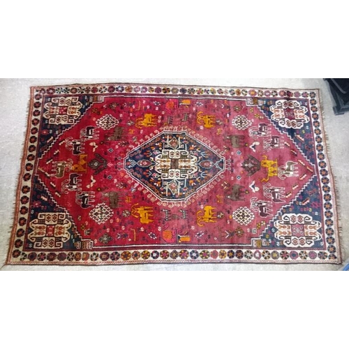 547 - Red Ground Persian 'Qashqai' Tribal Rug with animals, c.2.65m x 1.56m