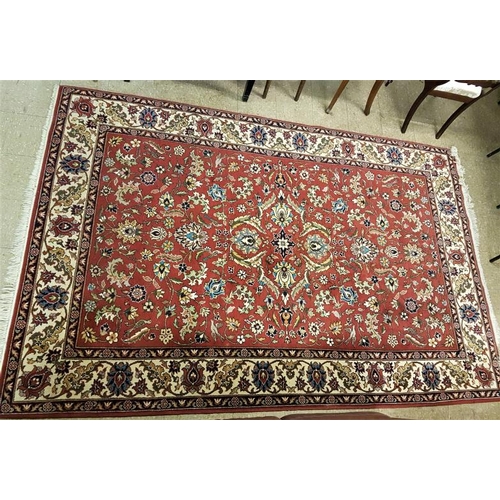 599 - Eastern Pattern Floor Rug with Floral Borders on a Red Ground, c.10ft x 7ft