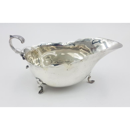 360 - Silver Sauce Boat with wavy rim and raised on pad feet, Hallmarked Birmingham c.1904, indistinct mak... 