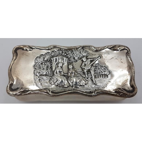 436 - Edwardian Silver Trinket Box which is embossed with a man playing a musical instrument to two women,... 