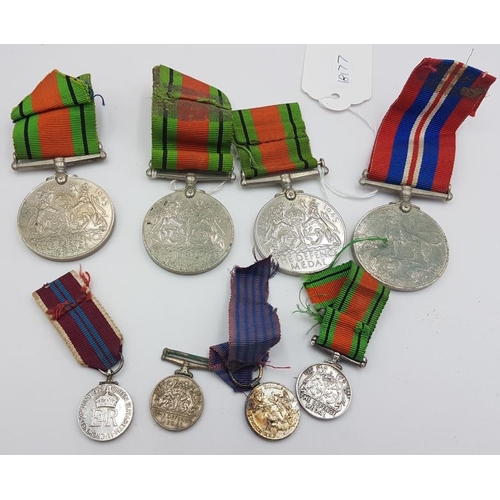 283 - Medal Group - Three WWII Defence Medals and a 1939-45 Medal, and two Miniature Defence Medals, and a... 
