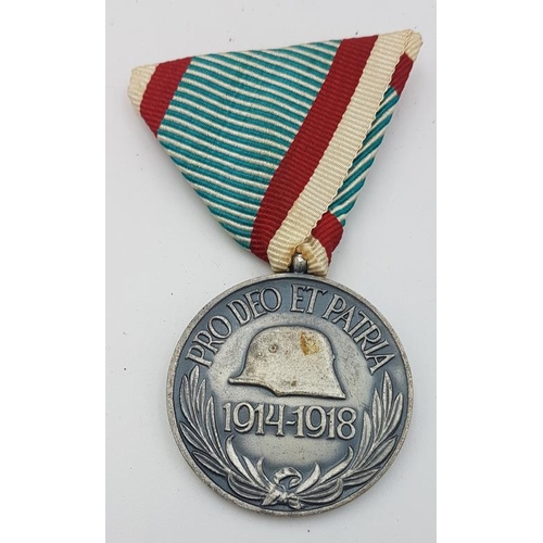 284 - Austrian Hungarian Medal WWI. The front shows the weapon shield of Hungary surmounted by a crown, wi... 