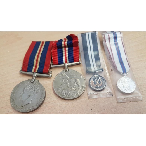 294 - Two 1939-45 War Medals, a miniature Distinguished Service Medal and a miniature 25 Year Reign of Eli... 