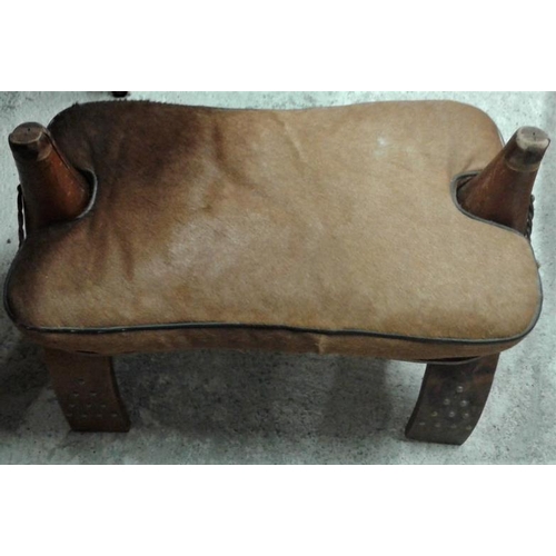 85 - Carved Camel Stool with metal stud detail, c.22in long, 17in tall