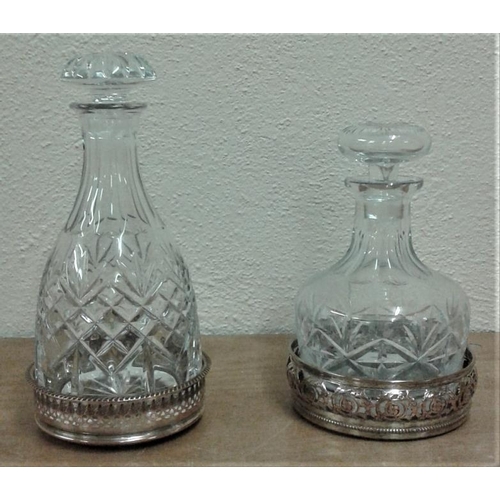 572 - Two Cut Glass Decanters with Stoppers and Two Pierced Plated Coasters