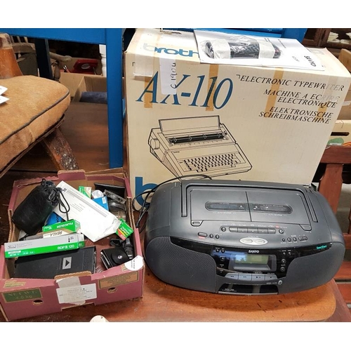 105 - Brother Electric Typewriter, Sanyo Portable CD Player and a box of camera equipment/accessories