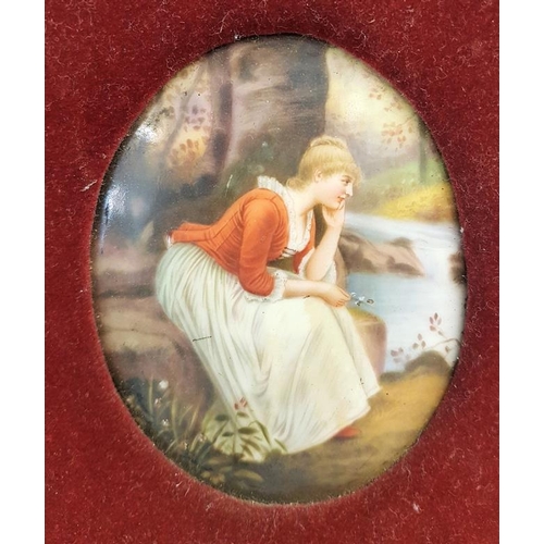 302 - A Small Oval Porcelain Plaque Painted with a Lady Seated near a Wood on a River Bank with a velvet s... 