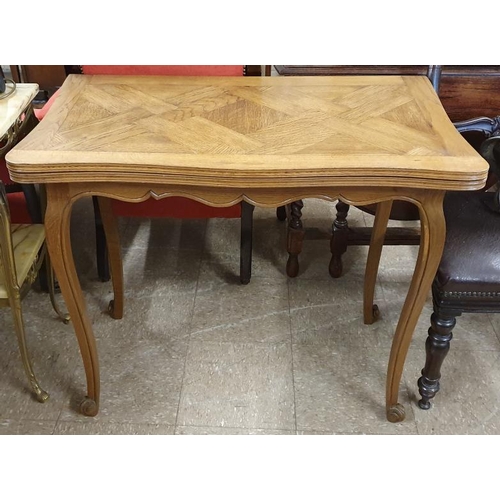 657 - French 20th Century Oak Fold Over Tea Table raised on Carved Cabriole Legs, c.36in wide (closed)