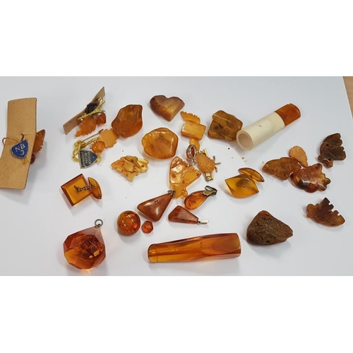 385 - Bag of Amber Items (rough and carved) - some silver mounted