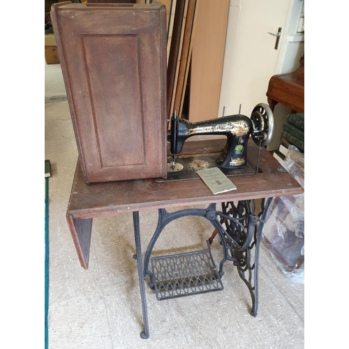 72 - Singer Sewing Machine on a cast iron base, with instruction manual