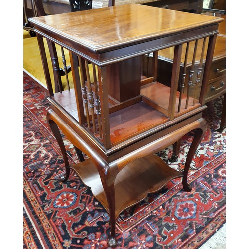 629 - Edwardian Inlaid Mahogany Revolving Bookcase with spindle supports, raised on cabriole legs united b... 