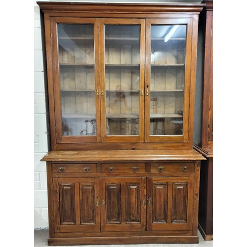 464 - Imposing Victorian Pitch Pine Bookcase, the moulded top above three glazed doors on a panelled base ... 