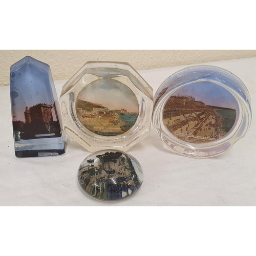 332 - Four assorted early 20th Century glass paperweights to include a Blarney Castle example, Scarborough... 