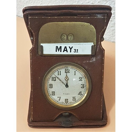 228 - Leather Bound Travelling Clock/Calendar.- 6ins long