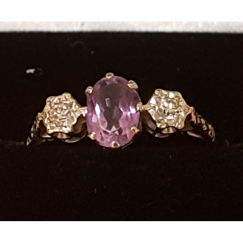 239 - 18ct Gold Diamond and Amethyst Ring. Central Amethyst stone flanked by diamonds, size O+1/2