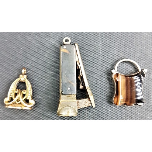 264 - 19th Century and later: Gold coloured fob, a miniature cigar cutter and an agate locket/charm
