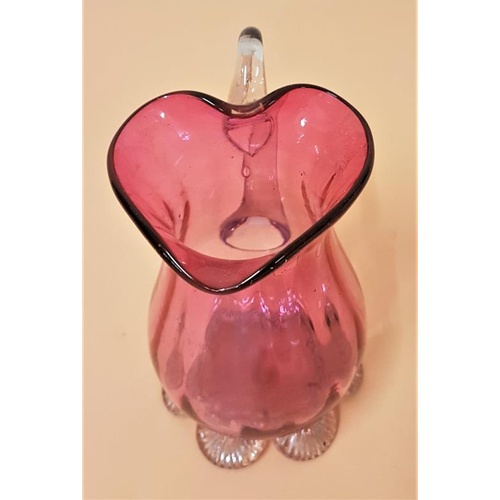 310 - 19th Century Ruby/Cranberry Glass Jug with six scalloped design clear glass feet - 11cm tall