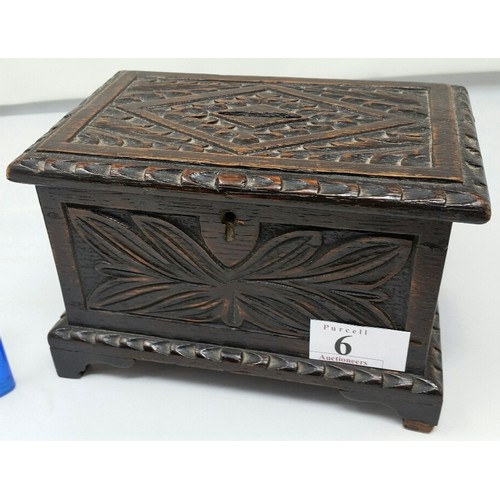 6 - A 19th Century carved oak money box in the form of a coffer, Floral carved design . T... 