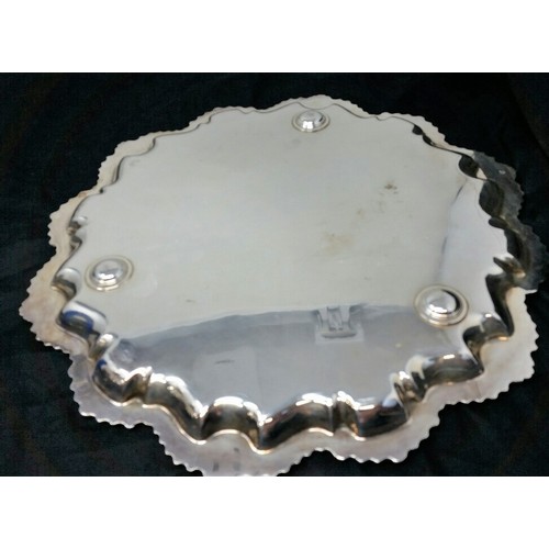 17 - A heavy quality silver plated serving tray 12 inches diameter and a heavy quality tea pot both in us... 