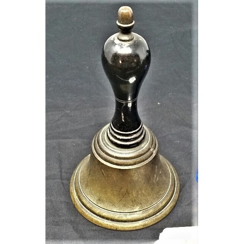 19 - a 19th Century servants bell. 6 inches tall brass cone and ebonized handle with clanger