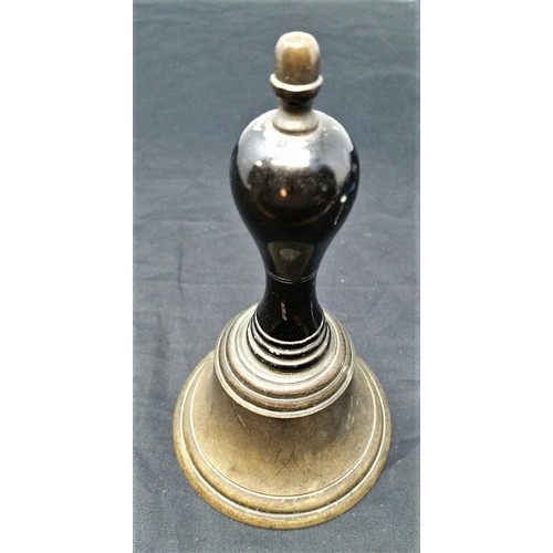 19 - a 19th Century servants bell. 6 inches tall brass cone and ebonized handle with clanger