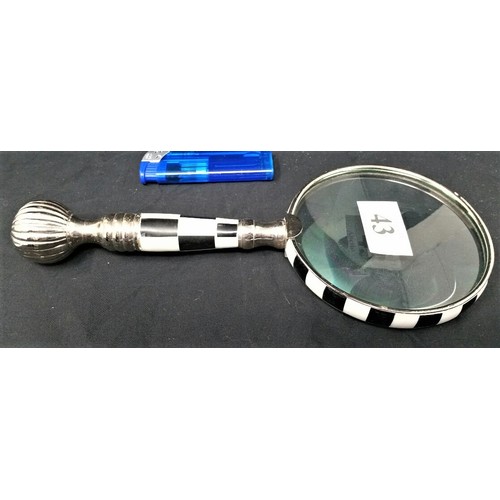 43 - A modern magnifying glass with black and white chequered design and chrome structure. 9.5 inches lon... 