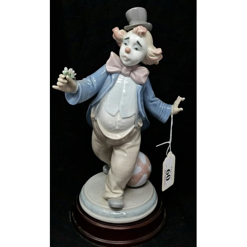 60 - Lladro figure 2002 on a wooden base 10.5 inches tall. No visible damage whatsoever.
