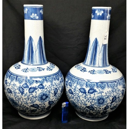 72 - A large pair of late 20th century bottle neck vases with underglaze blue floral pattern. No chi... 