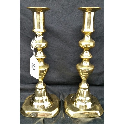 83 - A good pair of 19th Century brass beehive candlesticks with candle push 9 inches tall. A good u... 