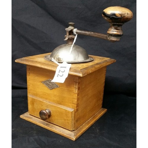 122 - A vintage coffee grinder in working condition.  No damages.  7.75 inches high x 5.5 inches... 