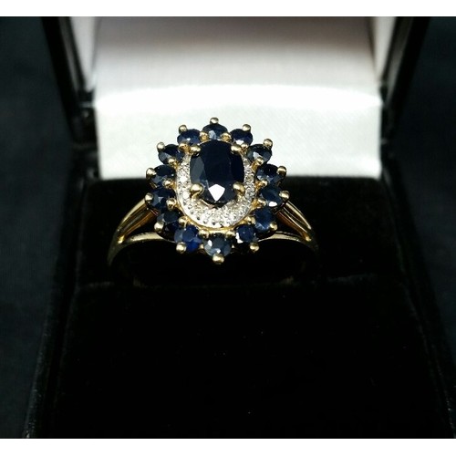 143 - 9ct Gold oval shaped Sapphire & Diamond ring.  Central oval sapphire surrounded by 12 diamo... 