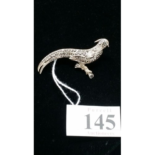 145 - A Sterling Silver brooch in the form of a peacock with emerald coloured eye 2.1 inches wide. Stamped... 