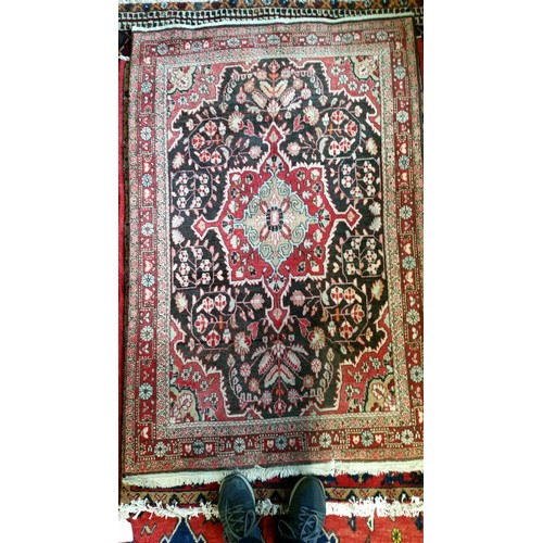 220 - A semi old handmade Iranian carpet with central medallion 100% pure wool full pile fringed to one en... 