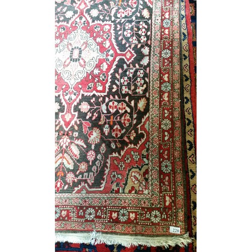 220 - A semi old handmade Iranian carpet with central medallion 100% pure wool full pile fringed to one en... 