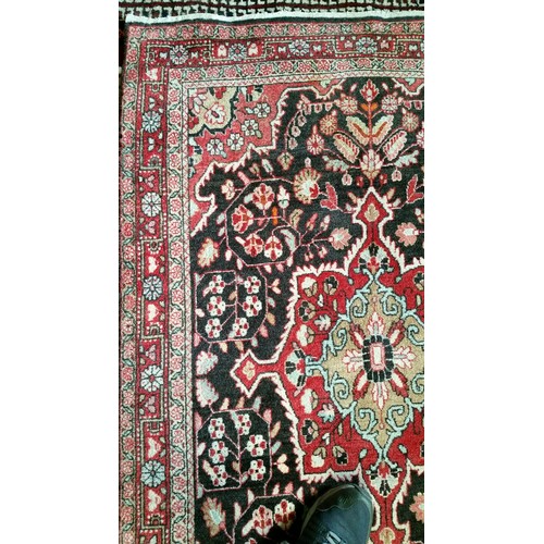 220 - A semi old handmade Iranian carpet with central medallion 100% pure wool full pile fringed to one en... 